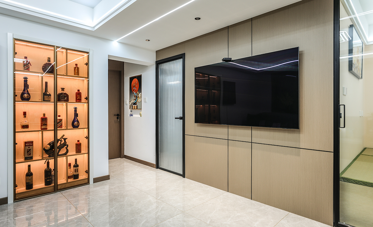 原先門洞的位置改造成酒柜，男主人有收藏酒類的習慣，加上燈光氛圍烘托，也可以當成端景背景使用。