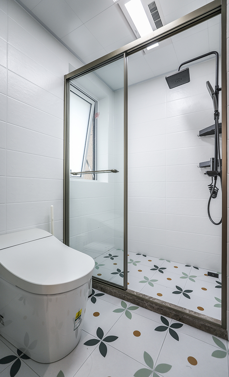 衛(wèi)生間濕區(qū)空間也很大，一個(gè)馬桶，一個(gè)淋浴房，金色邊框淋浴房，地面藝術(shù)花磚，大氣時(shí)尚，主人很滿意，不斷地夸贊設(shè)計(jì)師對(duì)色彩的精準(zhǔn)把握。