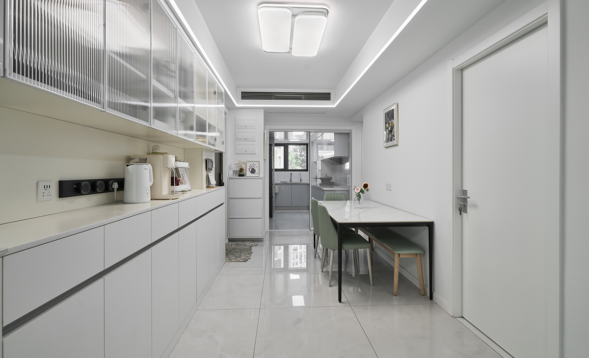  廚房與餐廳相連，采用綠色色系，使得櫥柜更有質感。