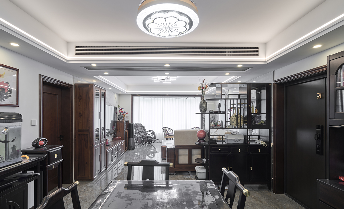 餐廳采用實木方桌，中式玄關(guān)，中式餐邊柜，體現(xiàn)中式風(fēng)格的簡潔時尚，方正大氣、矮柜上的魚缸很有仙氣，頂面中式吊燈，配上線型燈，讓空間溫馨、大氣。