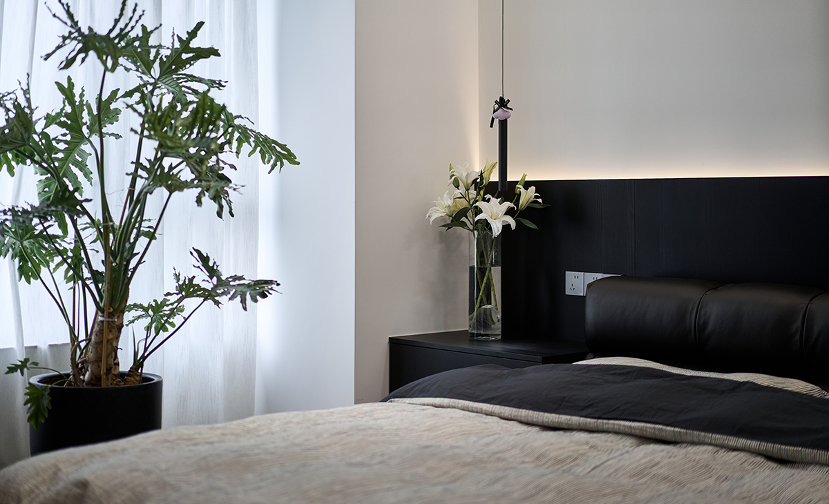 以 “黑 + 白 + 暖棕” 為基礎色調，通過白色百合花藝、彩色潮玩藏品點綴，打破暗調沉悶；大面積啞光材質與玻璃的組合，讓空間在 “厚重” 與 “通透” 間找到平衡。