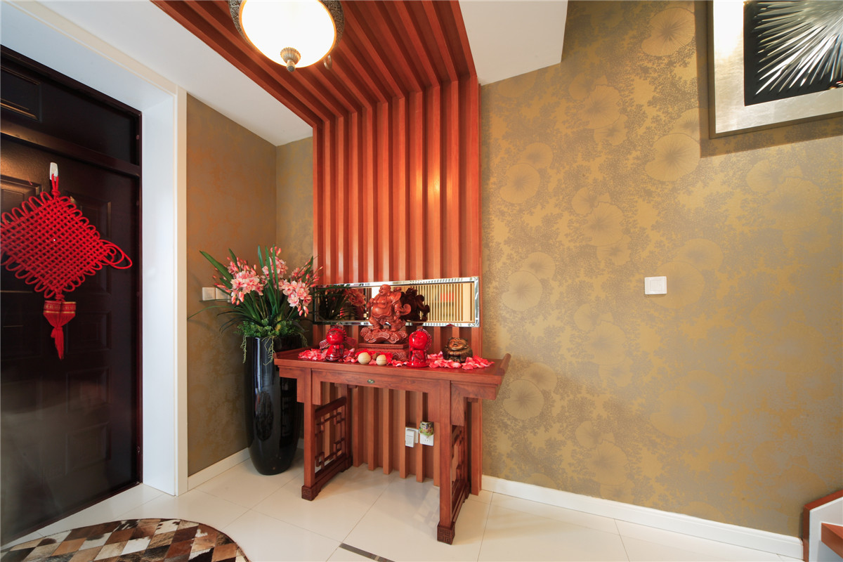 進門的玄關處采用了木飾面裝飾，對于業主是生意人的特性，設計了供臺位置，整個客廳的分水位在這里淋漓盡致。
