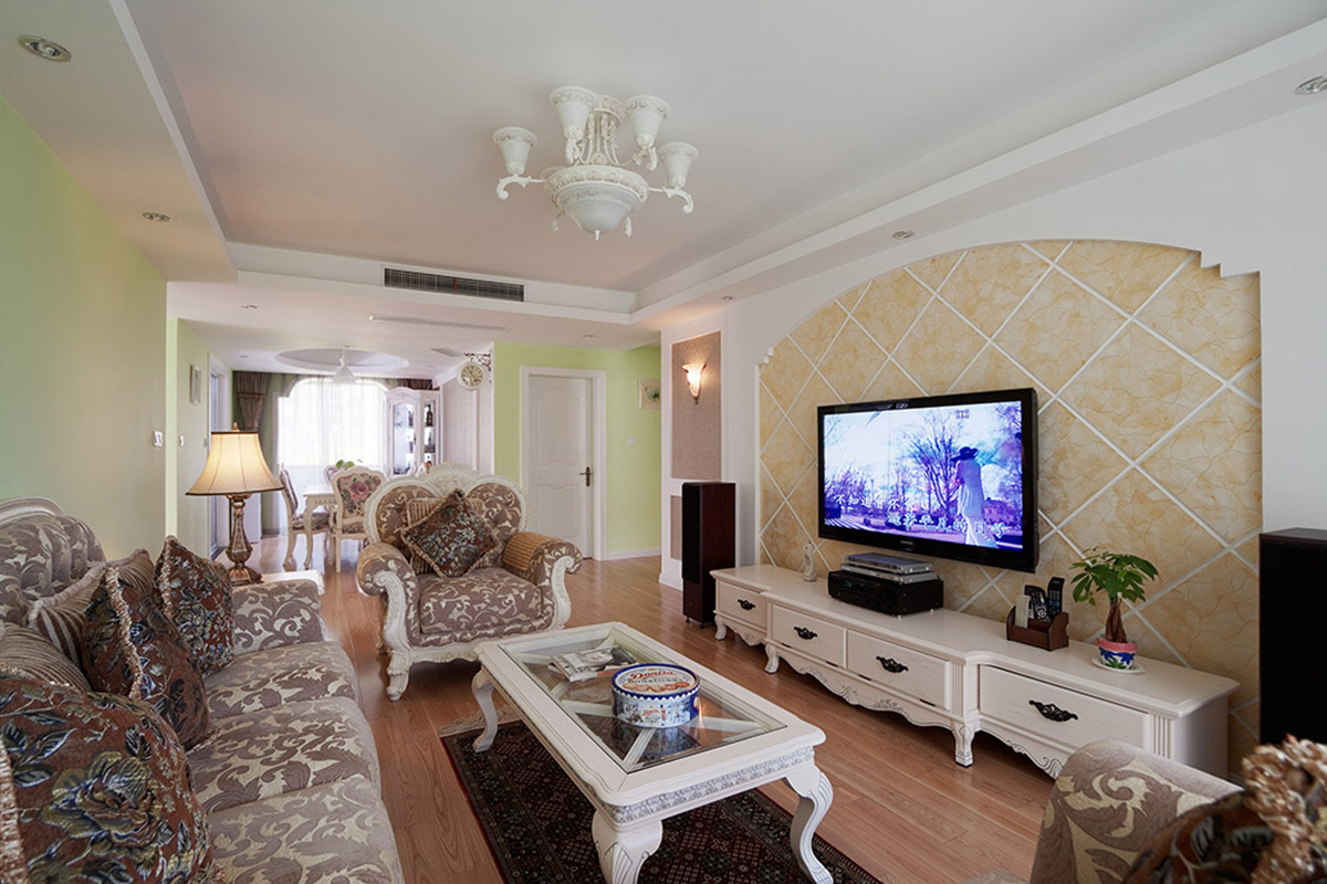 米色的背景墻和綠色的墻面形成強(qiáng)烈對(duì)比，厚重華美的復(fù)古風(fēng)家具和白色吊燈，使客廳的空間清新又不失華貴。
