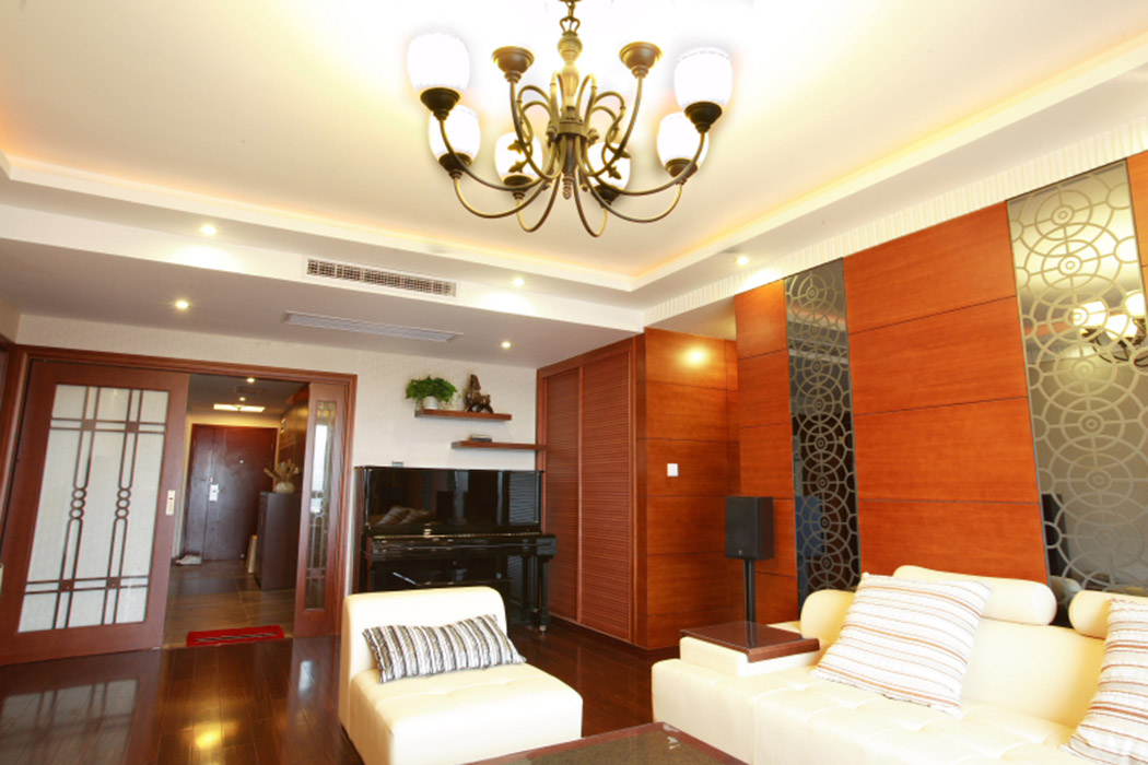 客廳的大部分墻面采用直紋櫻桃木的木紋貼皮，即提升了風水，也緩和了朝北的格局的冰冷。華麗的鐵藝吊燈，照射出一天新的開始。
