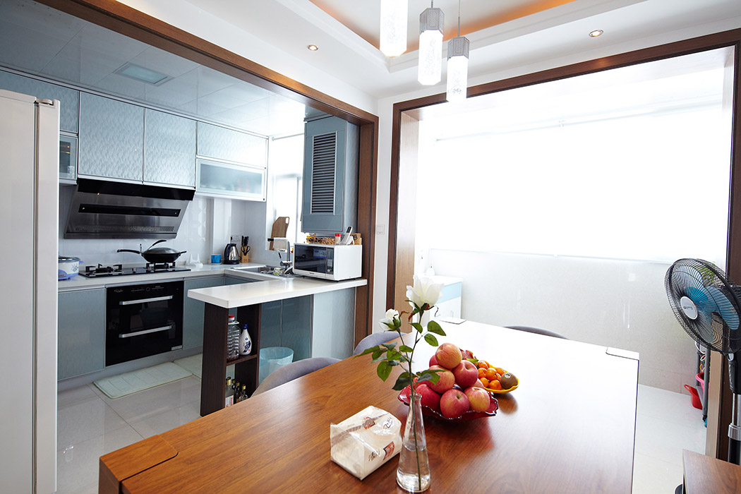 餐廳和廚房間用吧臺隔斷，本使狹小的廚房間和餐廳寬敞起來。陽臺的利用，更使整個餐廳明亮和寬敞。
