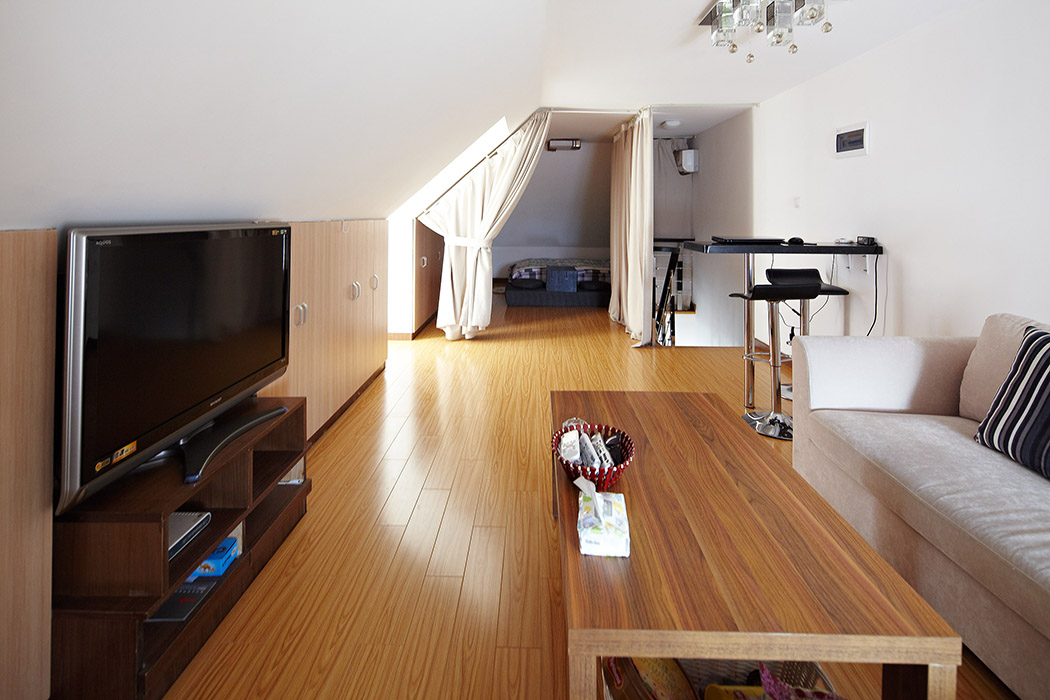 二樓的客廳簡潔而明了，電視背面的柜子設計讓原本不雅的客廳變得自然和時尚。儲藏功能的利用更是相當到位。
