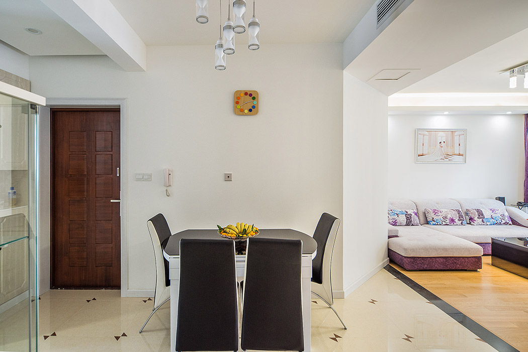 黑白搭配的餐桌，運用淺色的玻化磚來提亮過道的彩光，使得過道的光線得到立刻的提升，一進入室內就給人一種光線明亮的感覺，白色的房門加上黑色的門檻，使得這個經典的搭配體現的淋漓盡致。
