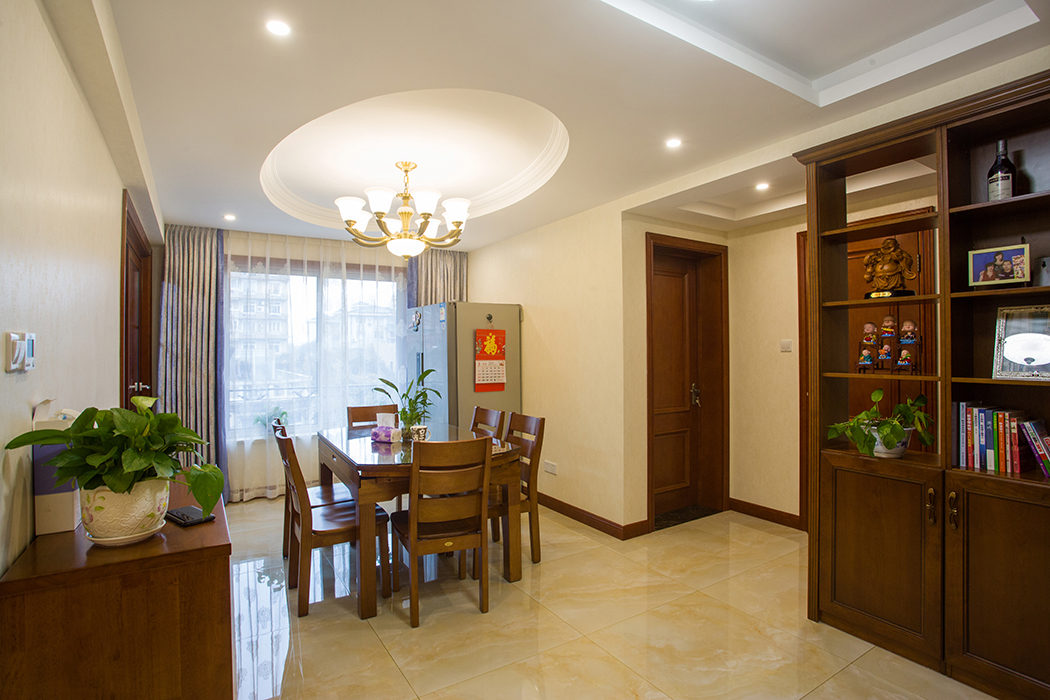 餐廳采用橢圓形吊頂，遵循“天圓地方”的風(fēng)水原理，深色餐桌，顯示出業(yè)主的成熟穩(wěn)定，色彩喜而不俗，不會讓在此處用餐聚會的人們感覺到壓抑。
