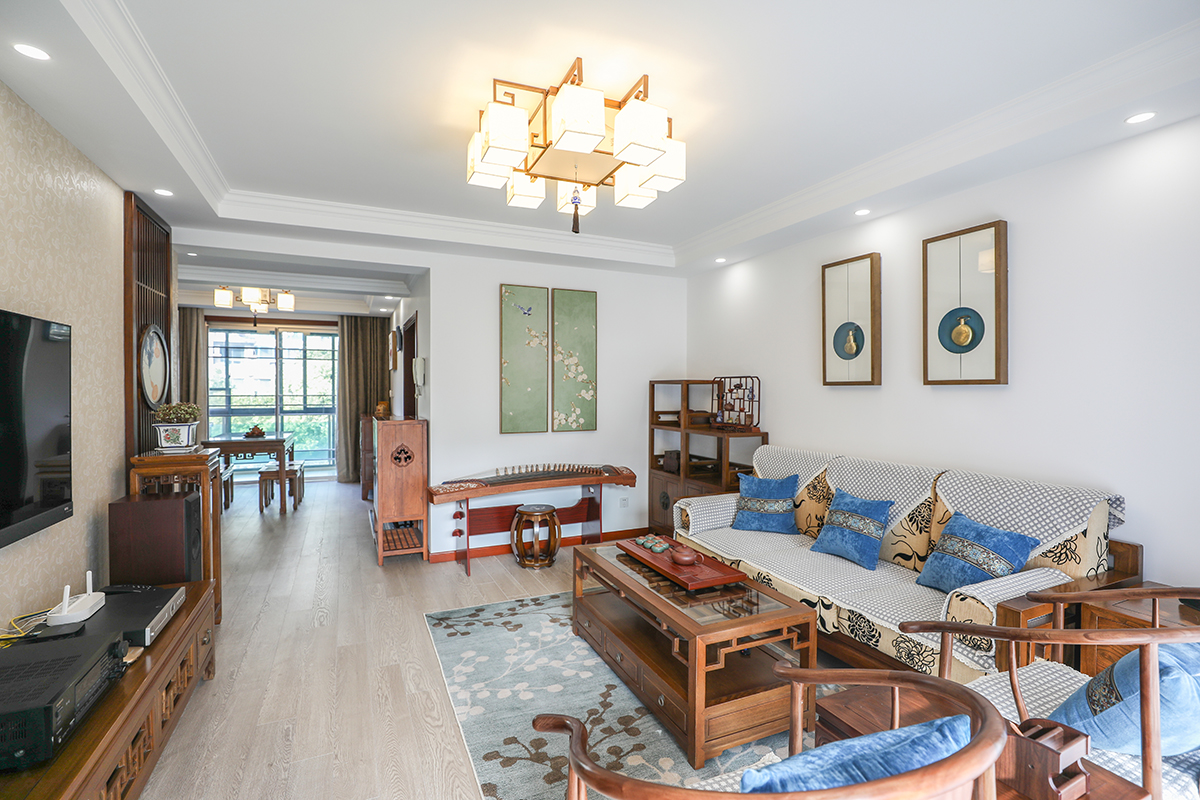 客廳整體風格采用大白墻風格，是當下比較時尚也是板式的處理方式，在顏色上做了統一，配上精致的木飾面花格及墻紙，把板式的硬線條做了軟性富有穩重。
