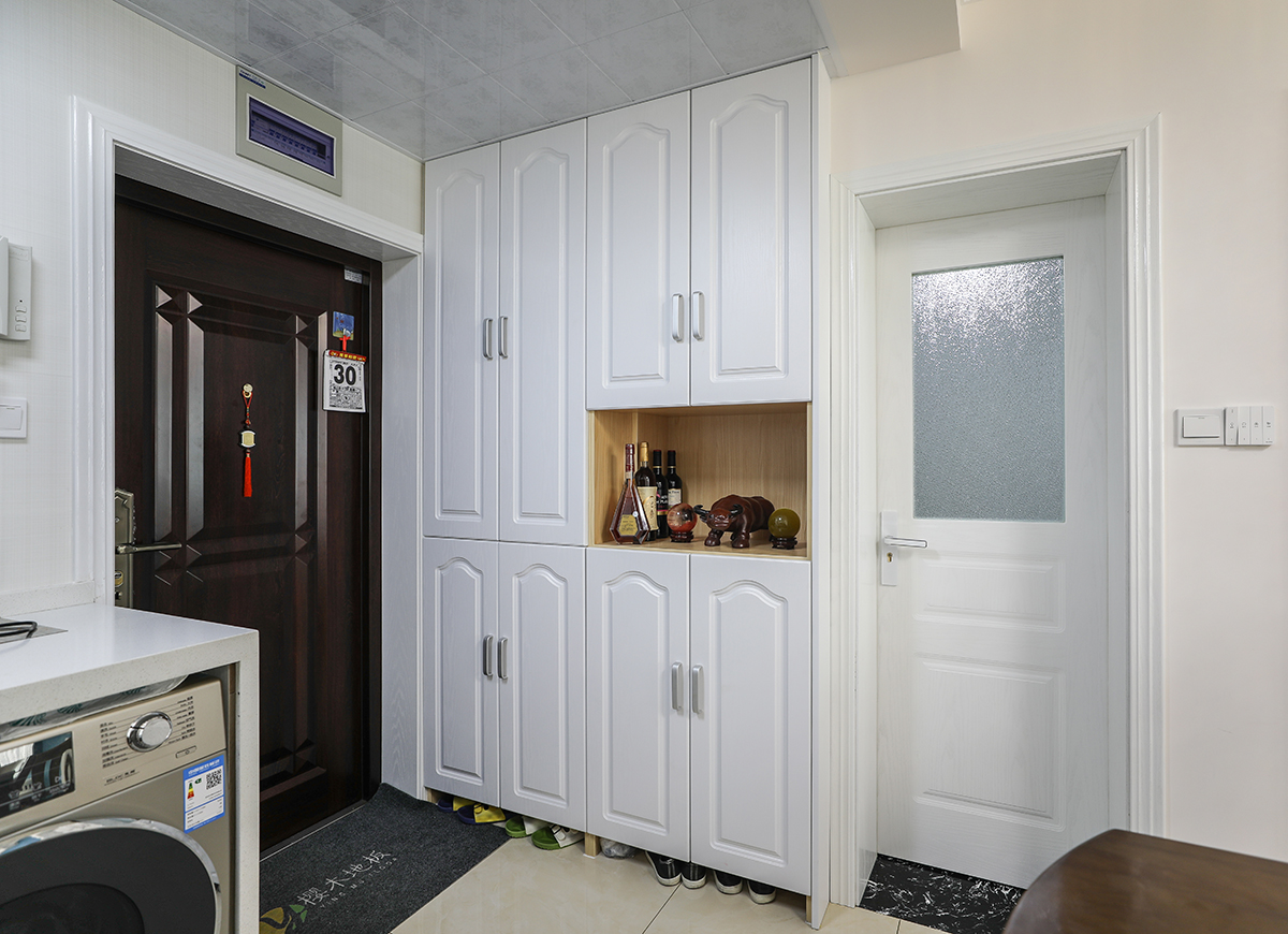 入戶過道處的進門鞋柜，巧妙的借用了原本衛生間的墻體，實用的同時也考慮了美觀。