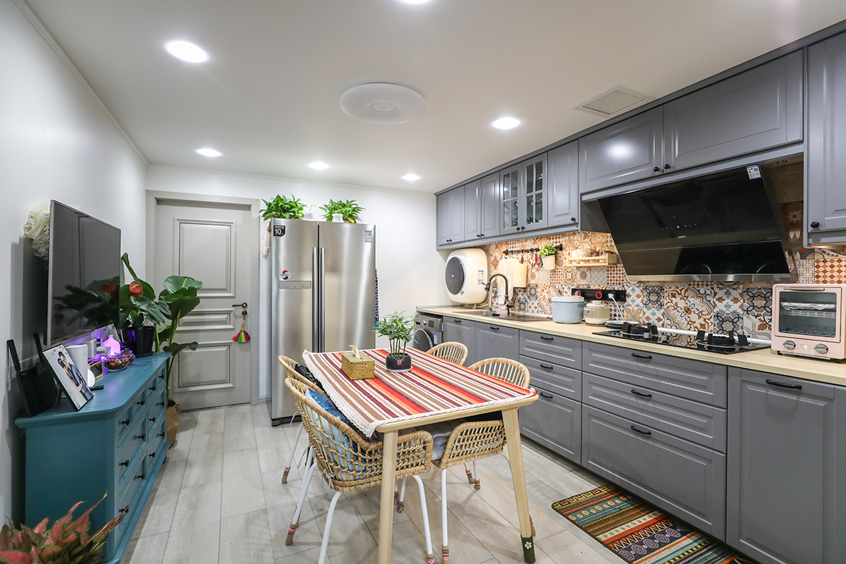 客餐廳地面選用地板磚，因為集合廚房區域，所以選用的是寬片地板磚。顏色需用淺灰，灰色百搭同時不會顯得空間過暗。電視柜選用了成品五斗柜集合了儲物及裝飾的功能。餐桌配以條紋桌布，色彩上與五斗櫥形成對比色。
