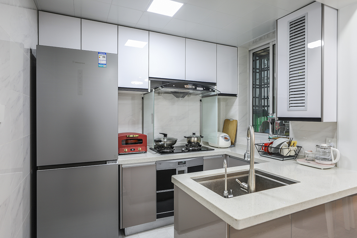 廚房做成了敞開式，因為空間不是特別寬裕，所以冰箱也都做成了嵌入式儲存功能更強，也使得空間變得整體，U字型的半開放設計令人感覺更大氣。
